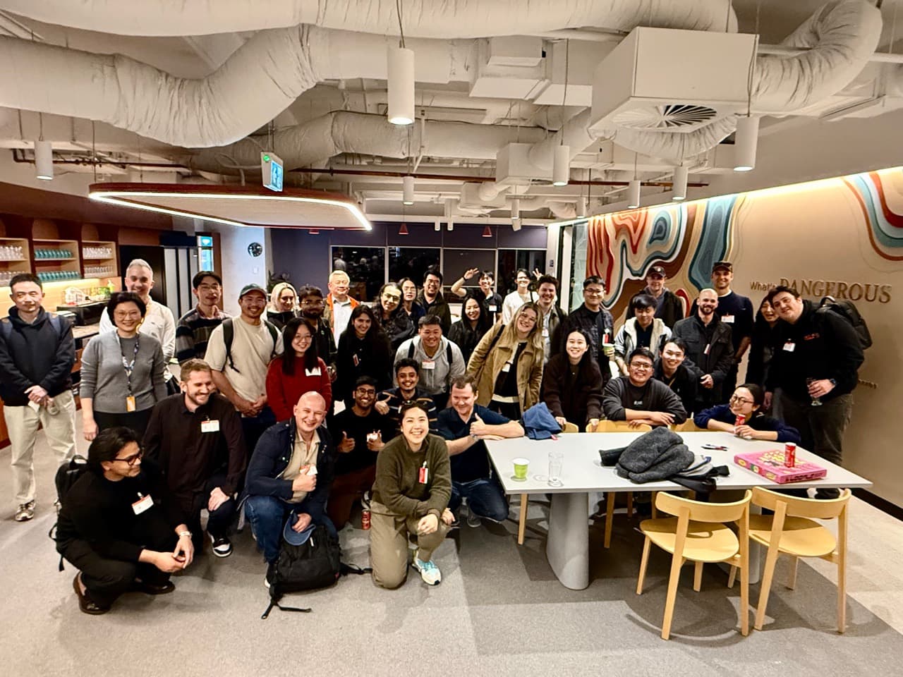 Attendees gathered around tables for a group photo at the first Codex meetup in Perth.